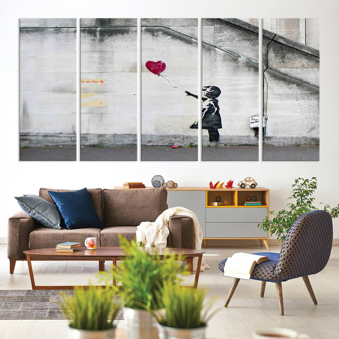 The "Girl with a Balloon Banksy Street Graffiti Art Canvas Print" is a gallery-quality wall art piece that features an image of a girl releasing a heart-shaped balloon. Handmade in the USA, this canvas artwork brings charm and emotion to any room.