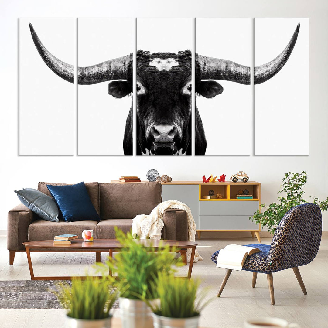 The living room is adorned with the Texas Cow Longhorn Wall Art Canvas Print in Black and White—framed and ready to hang.