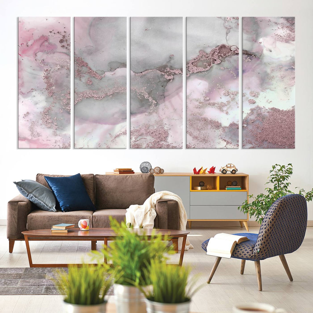 The Rose Marble Abstract Wall Art Canvas Print is a stunning triptych that showcases pink and gray tones, elegantly presented on a dark wall.