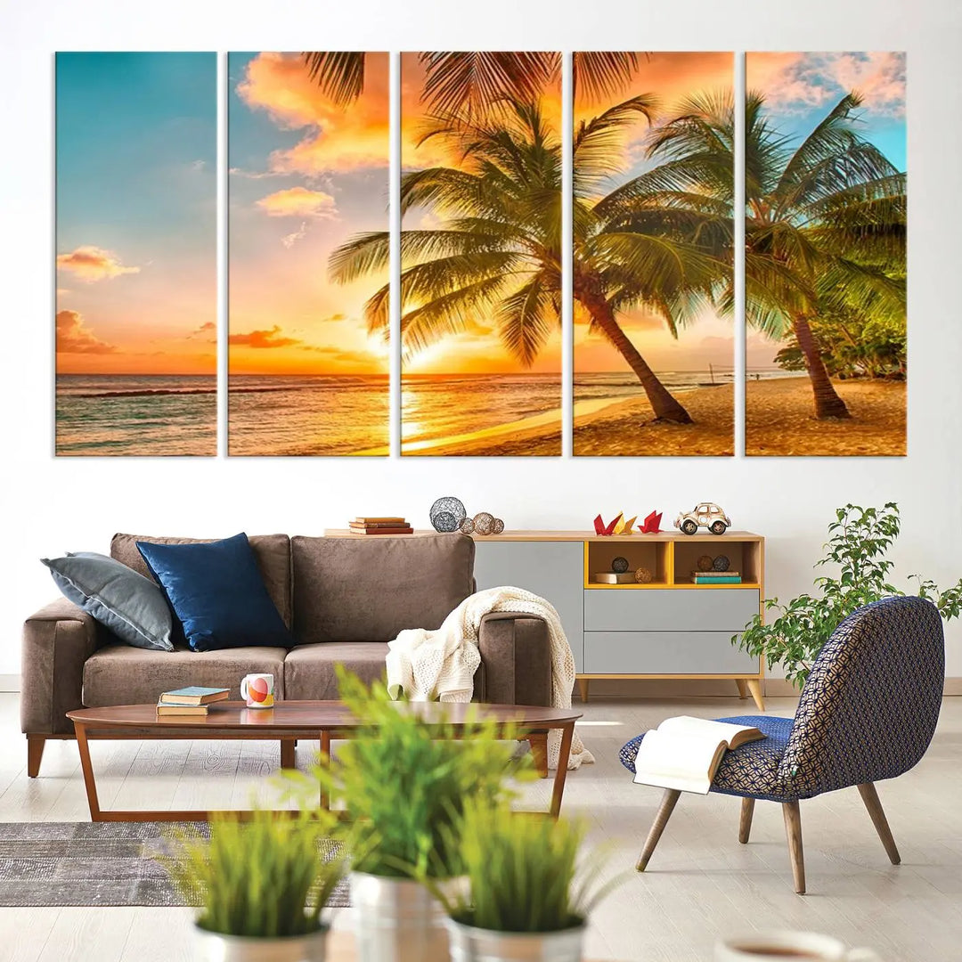 The Tropical Sunset Wall Art Print features a vibrant beach scene with palm trees and an ocean view highlighted by a golden sunset.