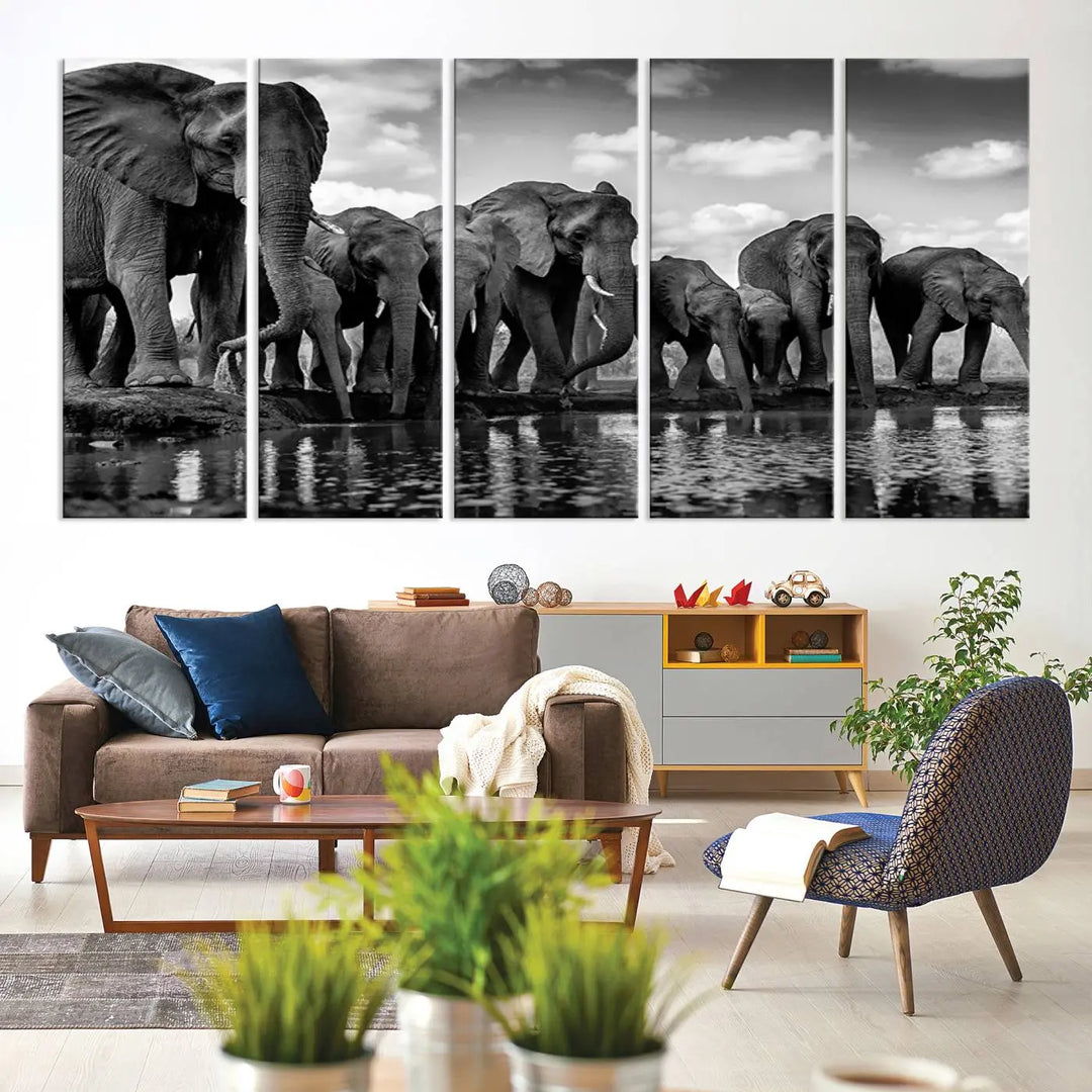 A stunning "Wall Art Animal Canvas Print" featuring a black and white photo of a herd of elephants drinking water is elegantly displayed, gallery wrapped on museum-quality canvas.