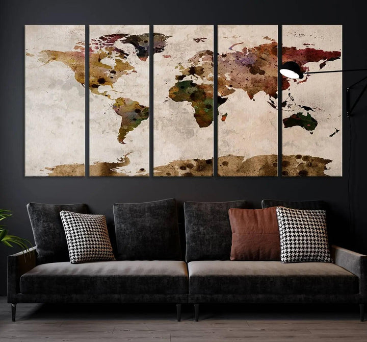 A Watercolor World Map Canvas Print, wrapped in an elegant gallery style, hangs on the wall.