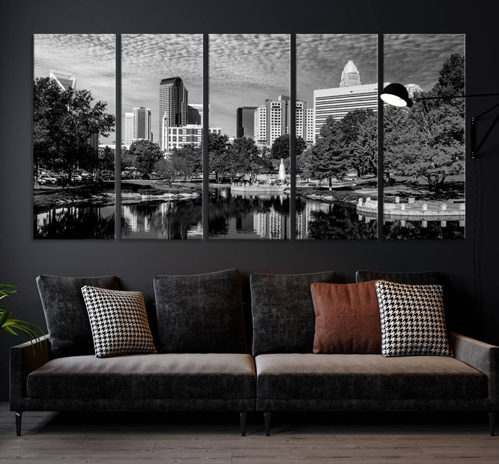 The living room features a captivating triptych titled "Charlotte City Cloudy Skyline Black and White Wall Art Cityscape Canvas Print," crafted on museum-quality canvas with UV-protective coating. Modern decor accentuates the dynamic scene.