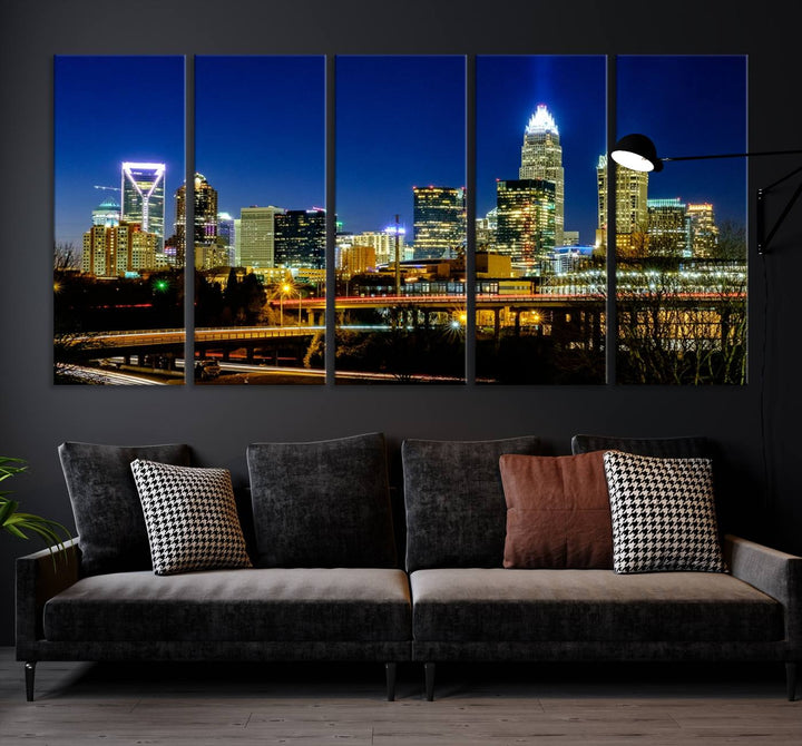 The Charlotte City Lights Night Blue Skyline Cityscape View Wall Art Canvas Print, showcasing an illuminated city skyline at night, is printed on museum-quality canvas with a UV-protective coating. Enhance your space with this stunning piece and enjoy free shipping with your purchase.