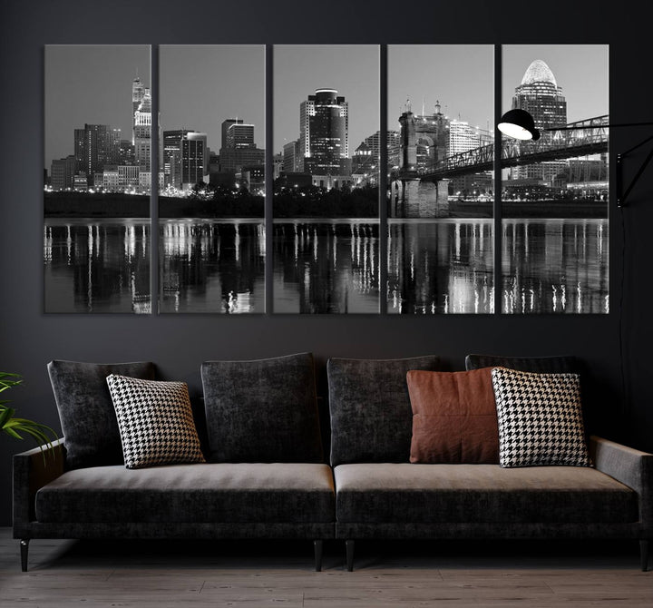 The wall showcases a ready-to-hang triptych of the Cincinnati City Lights Skyline in black and white, printed on museum-quality canvas.