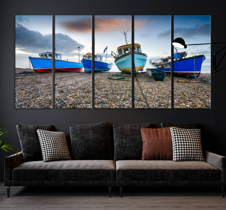 The "Big Boats On The Beach Wall Art Canvas Print" is a stunning piece featuring three museum-quality panels depicting fishing boats on a pebbled shore. Ready to hang and featuring UV-protective coating, it serves as an elegant addition to your home décor.