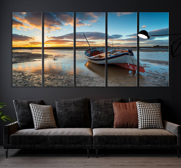 The "Small Boat At The Beach Sunset Wall Art Canvas Print," a three-panel masterpiece crafted on museum-quality canvas, hangs elegantly.