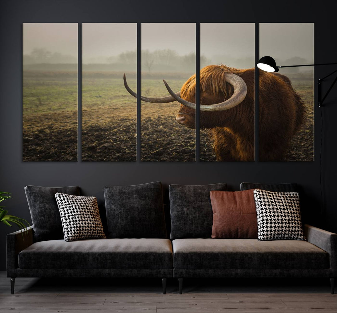 The "Big Cow Horn Wall Art Canvas Print" is a hand-assembled framed canvas depicting a Highland cow in a misty field. It is crafted with a UV-protective coating to ensure lasting vibrancy.