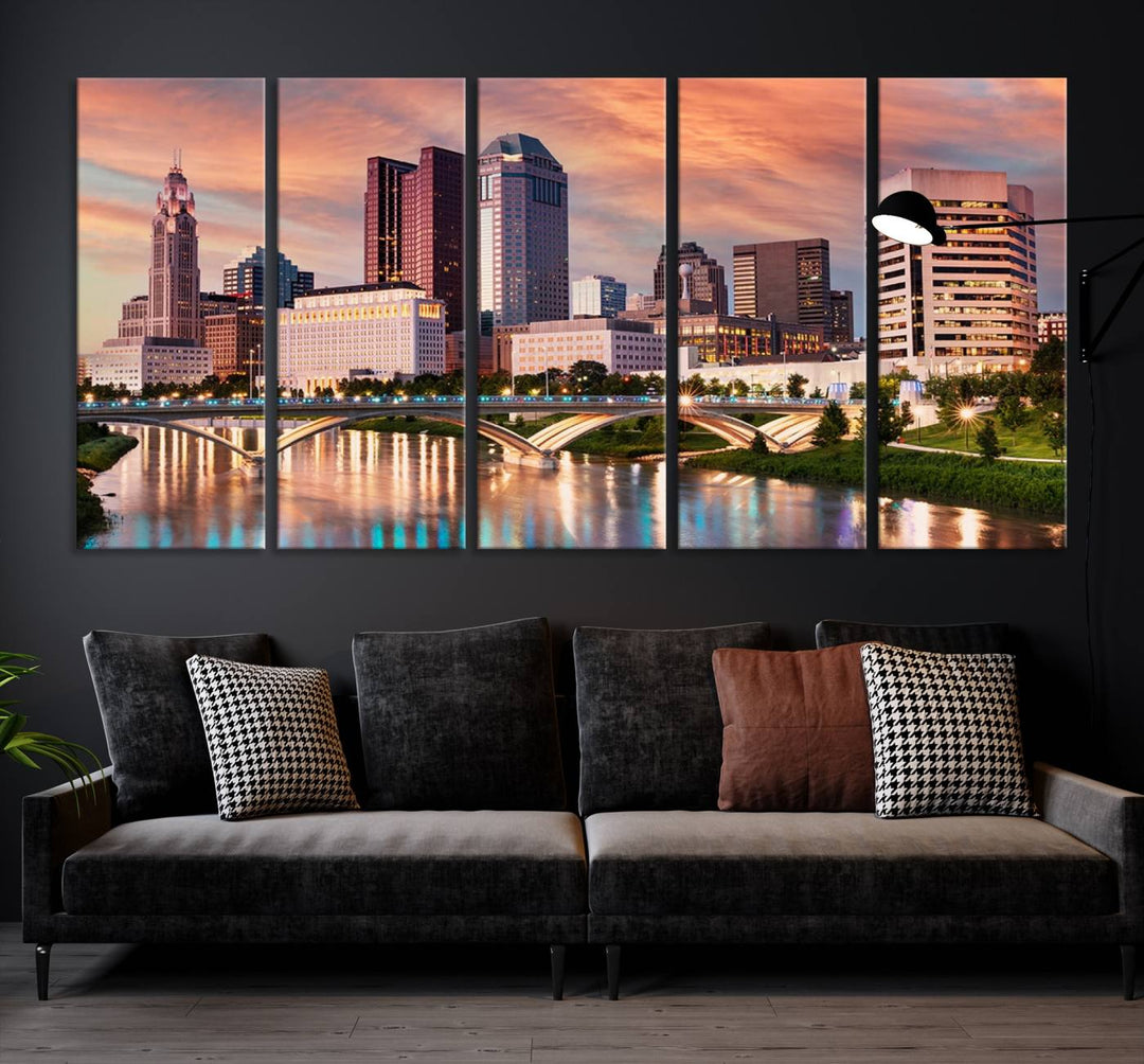 The "Columbus City Lights Sunset Orange Cloudy Skyline Cityscape View" wall art is featured on the wall. This triptych is printed on museum-quality canvas and includes a UV-protective coating, ensuring lasting vibrancy.