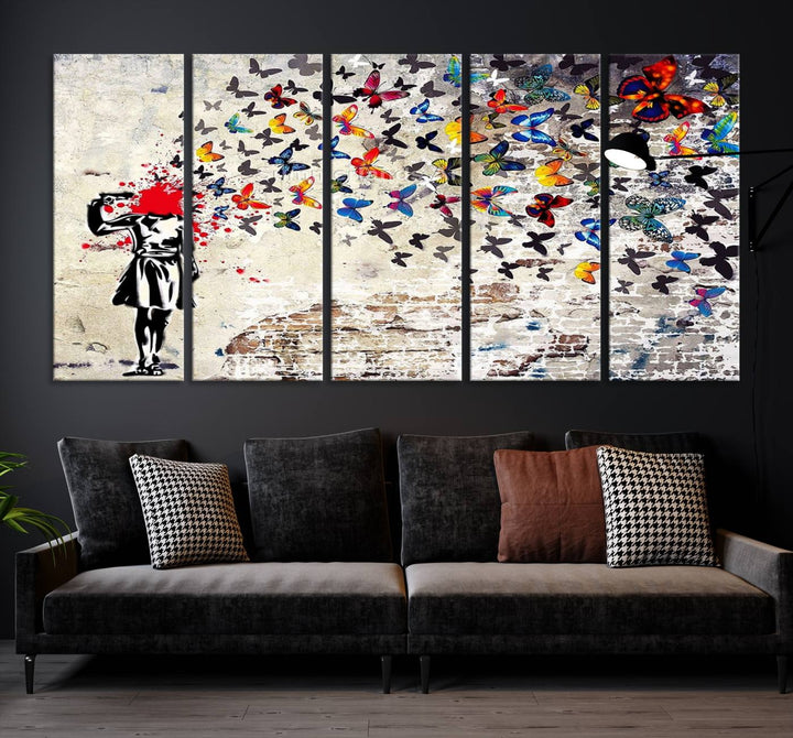 The Banksy Art Butterfly Girl Explosion Canvas showcases a dynamic figure with butterflies bursting from their head, set against a textured wall background. This vibrant urban graffiti piece is perfect for modern interiors and comes ready to hang.