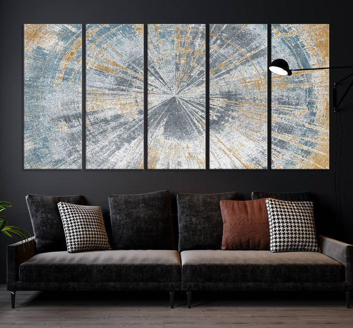 The Radiant Abstract Wood Rings Canvas Art, a modern triptych wall decor, enhances the contemporary style of the living room with its blue, white, and gold hues.