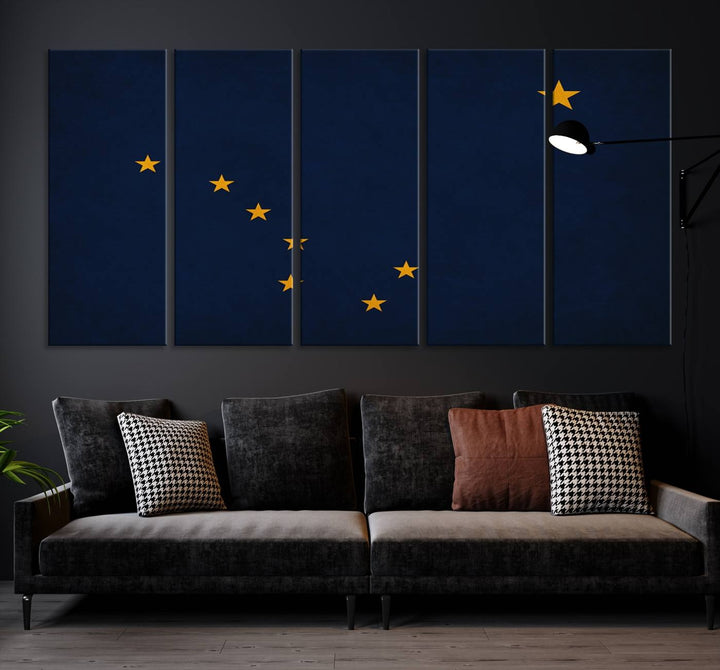 A contemporary living room featuring a triptych artwork of stars on a navy background, accentuated by the striking Alaska States Flag Wall Art Canvas Print.