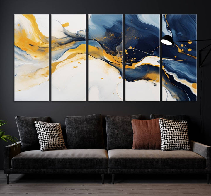 The Blue and Gold Abstract Fluid Canvas Art, with its swirling patterns, adorns the wall. This modern wall art beautifully complements the contemporary interior decor, adding an elegant touch with its rich blue, gold, and white tones.