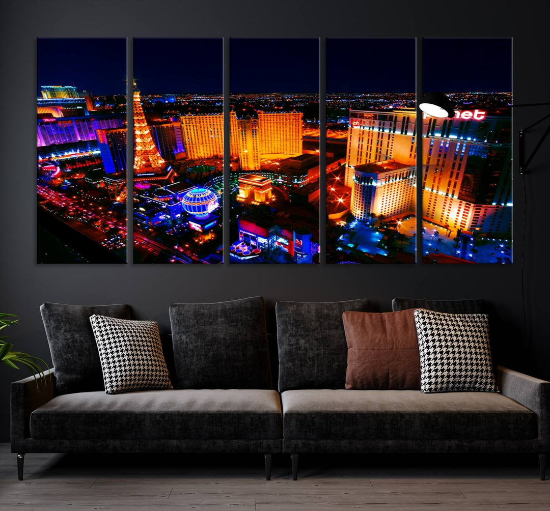 Las Vegas Wall Art Canvas Print showcases a dynamic and luminous cityscape at night with tall buildings and bustling streets. Expertly printed on museum-quality canvas, this gallery-wrapped artwork is enhanced with a UV-protective coating to ensure lasting brilliance.