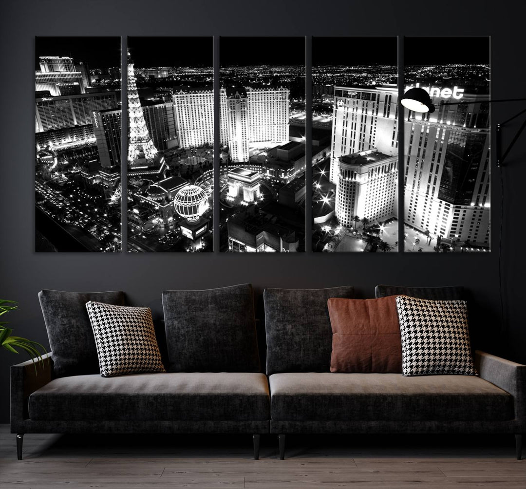 The Las Vegas Wall Art Canvas Print is a black and white triptych that showcases a city skyline at night. Crafted on museum-quality canvas with a UV-protective coating, it serves as an elegant and ready-to-hang focal point in the room.