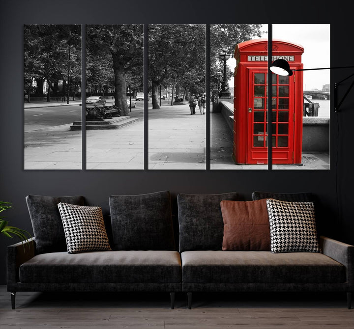 The London Phone Club Wall Art is a stunning piece that showcases a red telephone box set in a black and white street scene on museum-quality canvas. It is gallery wrapped with a UV-protective coating to preserve its vibrant charm.