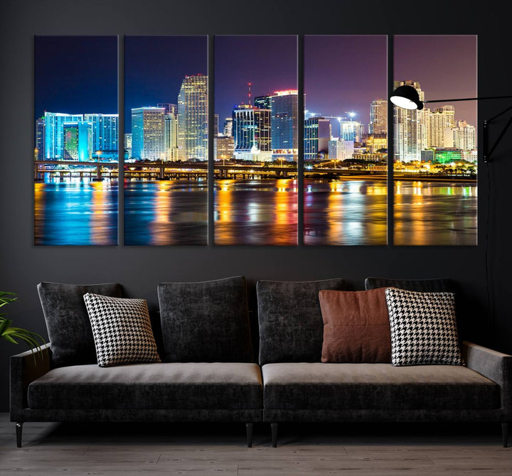 The Wall Art MIAMI Canvas Print features a stunning triptych of a city skyline at night, with vibrant lights reflecting on the water. This gallery-wrapped piece on museum-quality canvas delivers an exquisite finish.