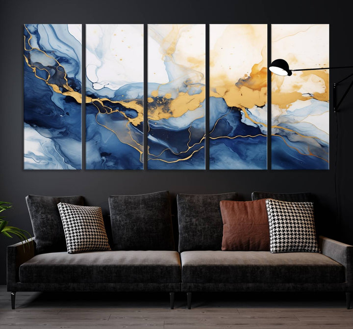 A contemporary living room featuring the "Navy Blue Gold Abstract Wall Art Canvas Print" on the wall, displayed on a gallery-wrapped, museum-quality canvas.