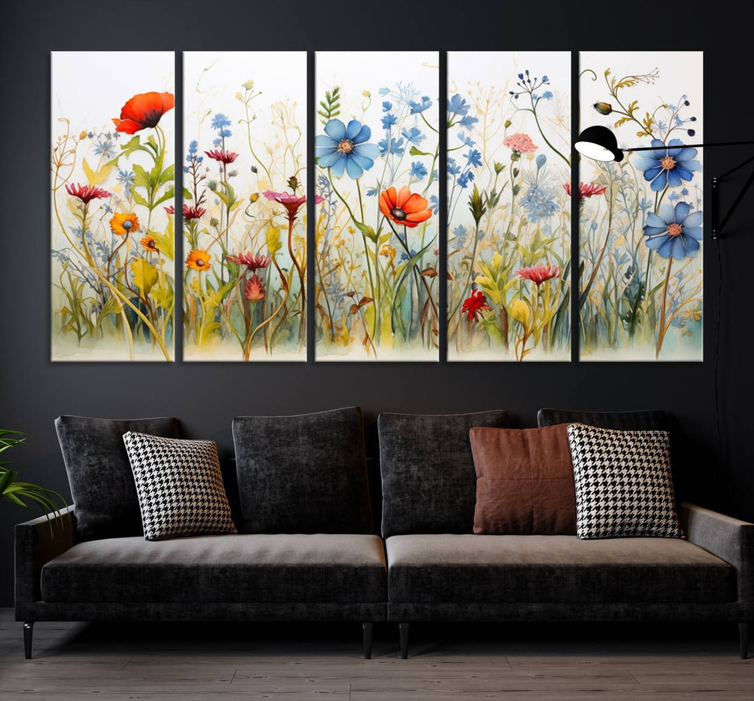 The Colorful Wildflower Canvas Wall Art – Vibrant Floral Botanical Print, consisting of a large 3 panel set, adds bright nature decor to the living room against a black wall.