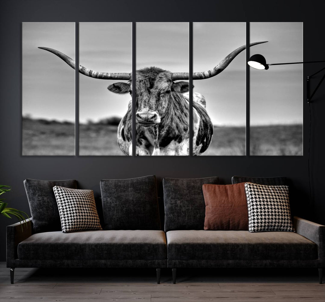 The Texas Longhorn Cow Wall Art, featuring a black and white image of a longhorn bull on canvas, brings charm to the room with its sophisticated appeal.