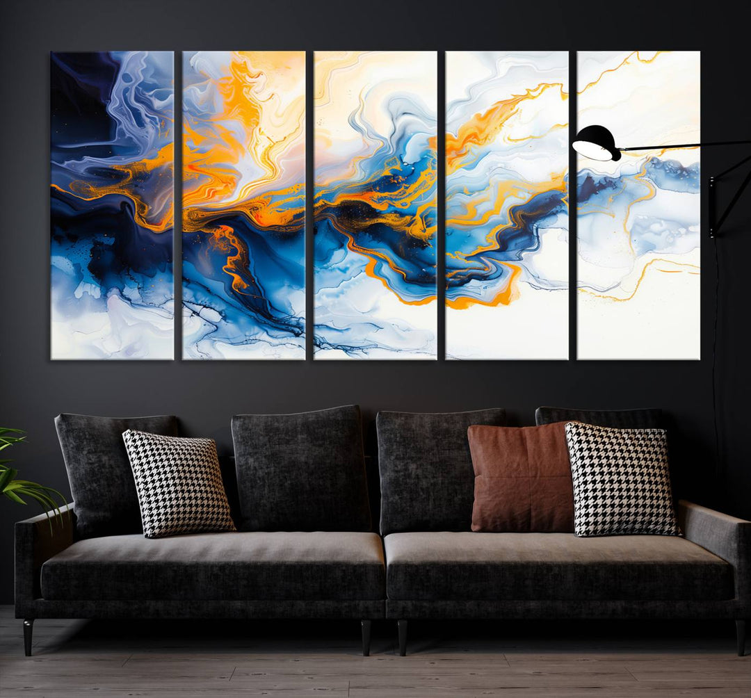 A stunning Fluid Alcohol Ink Wall Art with Gold Wall Art Canvas Print, featuring vibrant blue, orange, and white swirls, adorns the wall. This gallery-quality finish adds an exquisite touch to any living space.