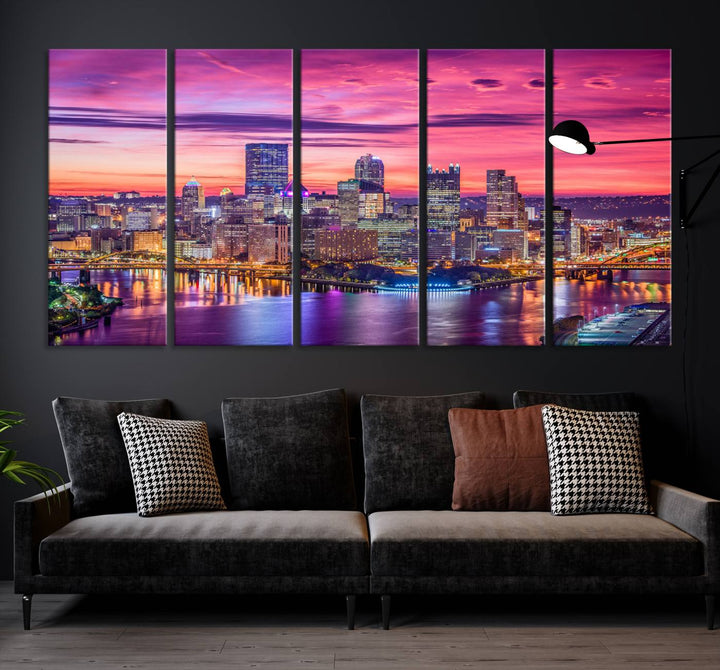 The Pittsburg Wall Art Canvas Print, showcasing a vibrant sunset glow over the city skyline and crafted by a professional artisan, adorns the space.