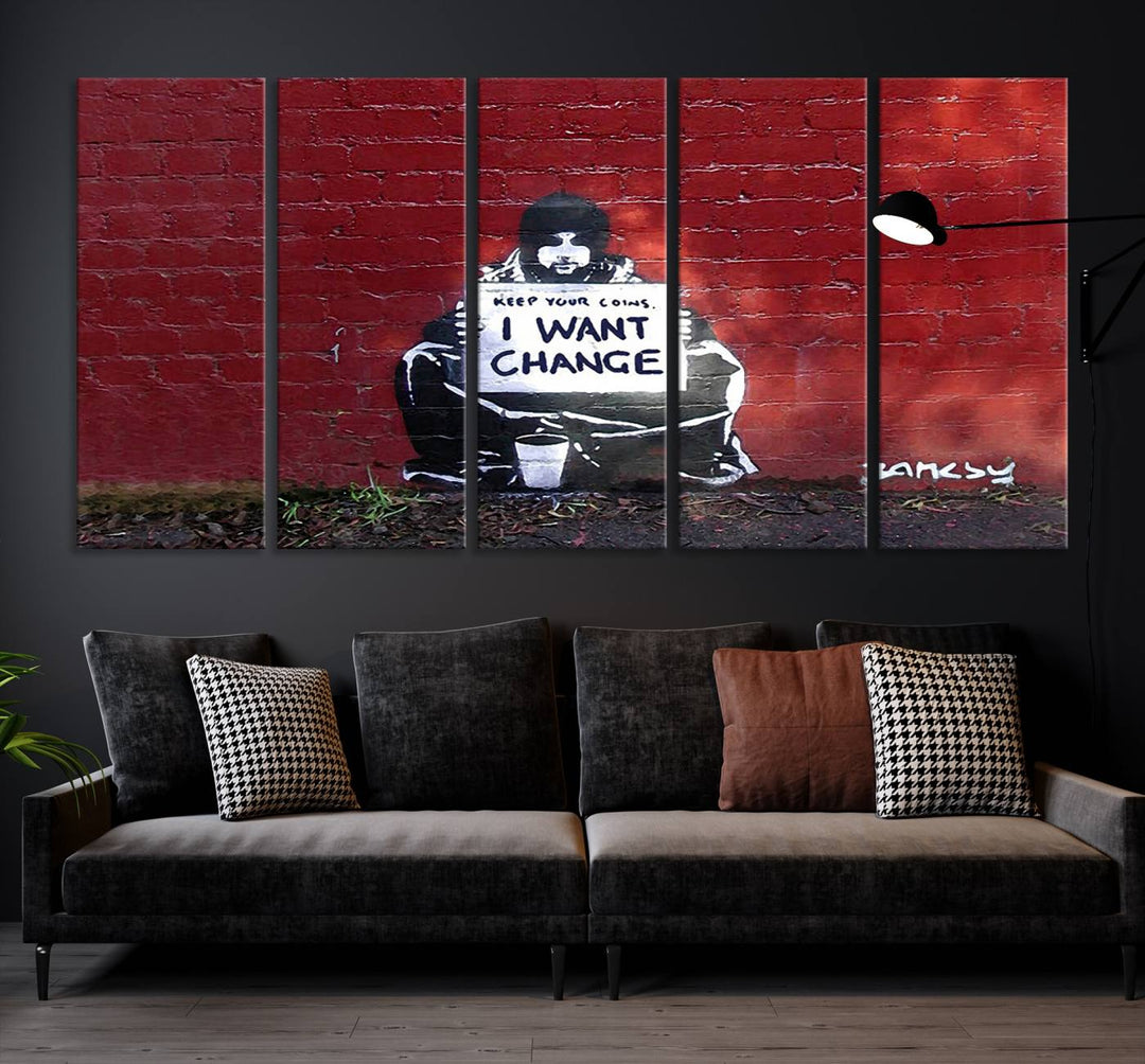 The living room showcases a triptych of stencil artwork on museum-quality canvas, featuring the Banksy I Want Change Graffiti Abstract Wall Art Canvas Print. This captivating piece depicts a person holding a sign that says "I want change" and is finished with a UV-protective coating to ensure long-lasting beauty.