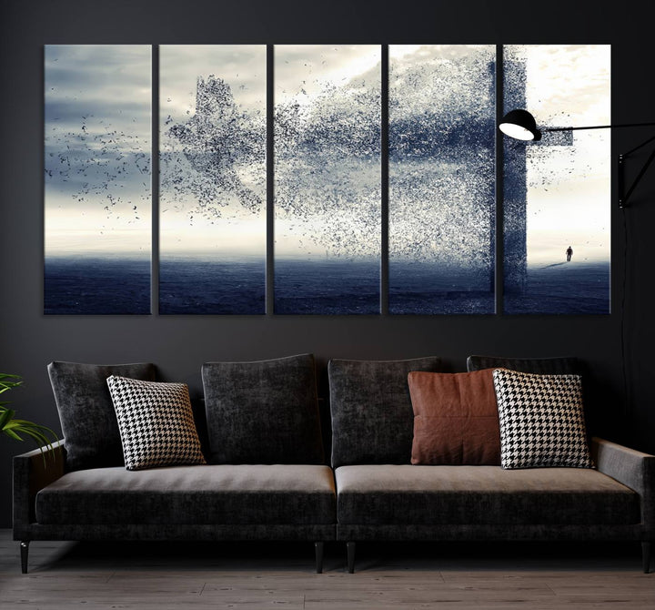 The "Jesus and the Fading Cross – Symbol of Faith" framed canvas print beautifully depicts a cross formed by birds against a moody sky above an ocean. This piece of Christian wall art infuses spirituality into the minimalist space.