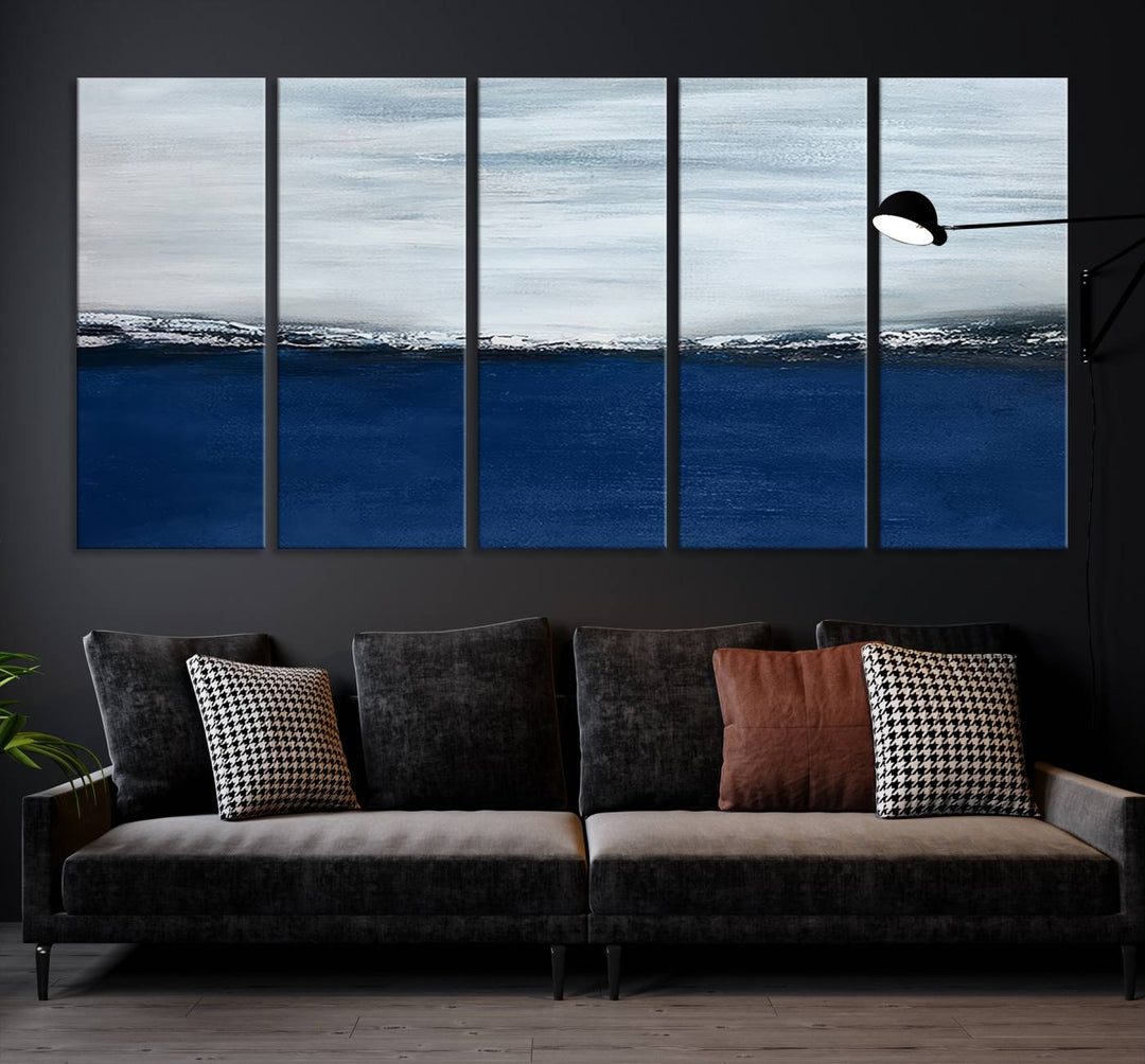 The modern living room is enhanced by the Navy Blue Abstract Wall Art Canvas Print on the wall, crafted as handmade wall art with a gallery-quality finish.