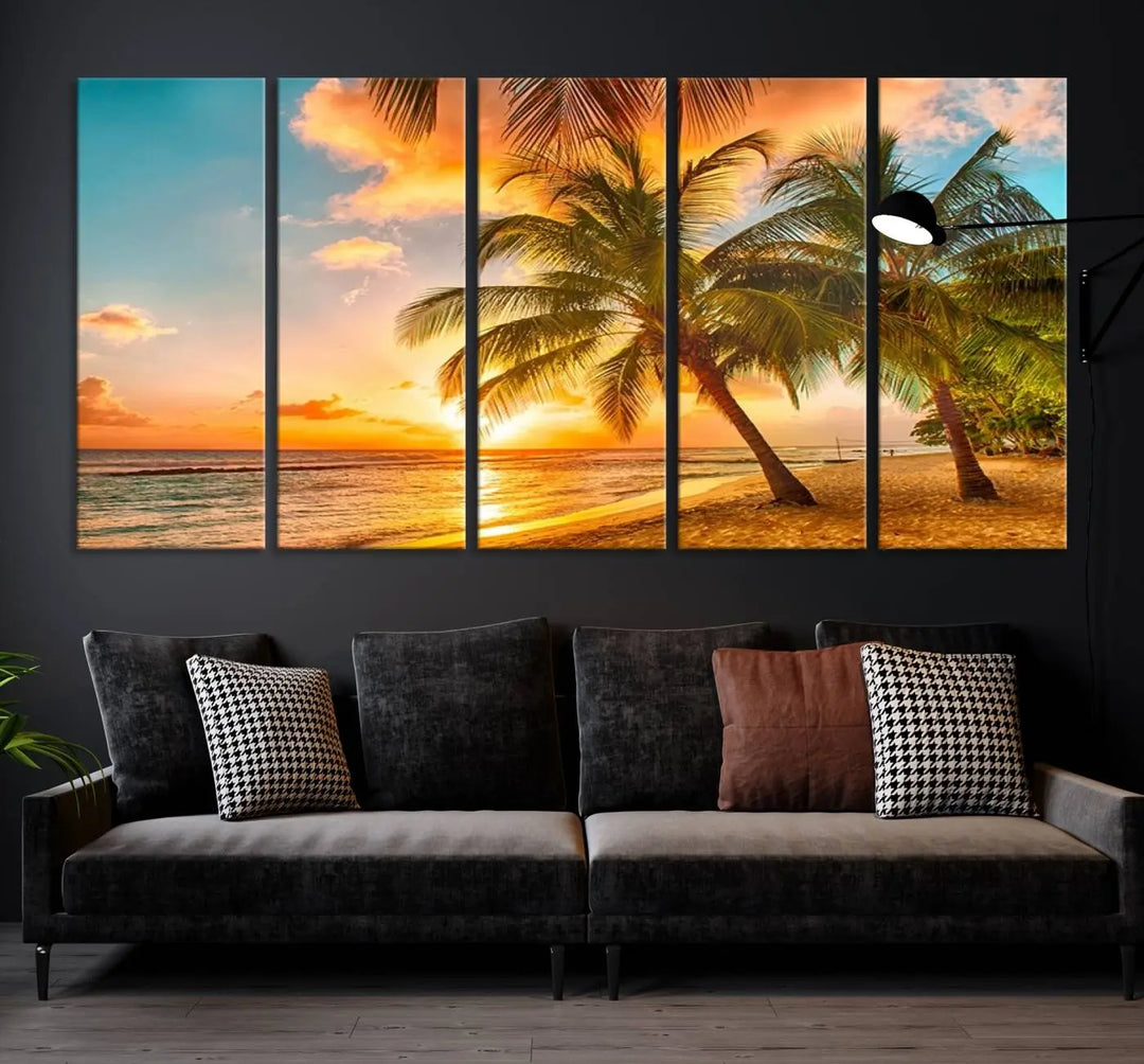 The Tropical Sunset Wall Art Print features a vibrant beach scene with palm trees and an ocean view highlighted by a golden sunset.