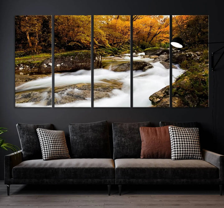 The living room is adorned with the "Wall Art Waterfall Canvas Print River in Forest in Autumn," a triptych on museum-quality canvas showcasing a flowing river surrounded by autumn trees. This ready-to-hang artwork features a UV-protective coating to ensure enduring vibrancy.