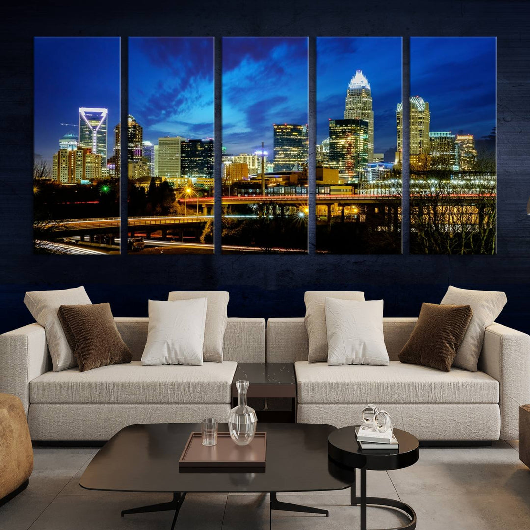 A modern living room highlighted by the "Charlotte City Lights Cloudy Blue Night Skyline Cityscape View" wall art canvas print, crafted on museum-quality canvas with UV-protective coating.