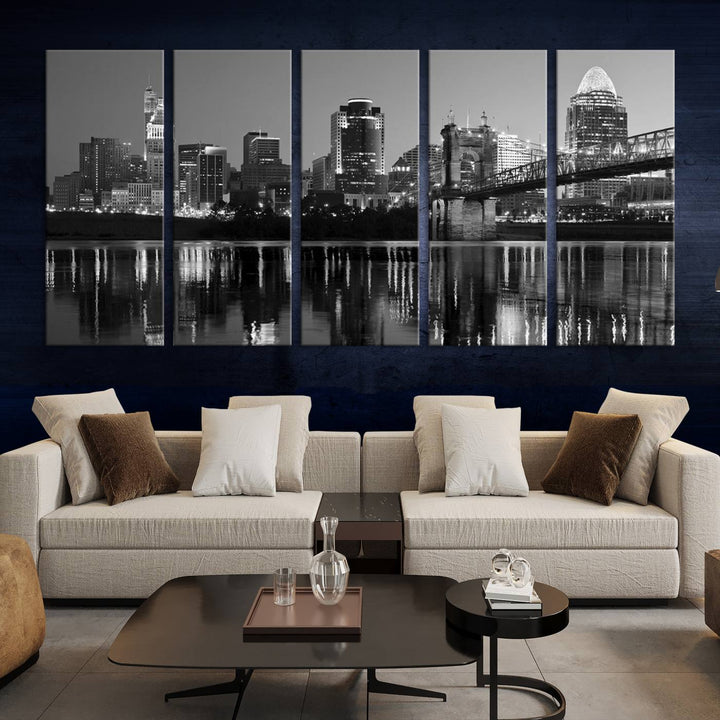 The wall showcases a ready-to-hang triptych of the Cincinnati City Lights Skyline in black and white, printed on museum-quality canvas.