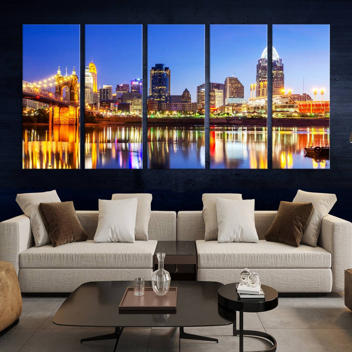 The "Cincinnati City Lights Night Skyline Cityscape View Wall Art Canvas Print" is a gallery-wrapped, museum-quality canvas illustrating a lit-up bridge and skyline at night. Enhanced with a UV-protective coating, this piece ensures lasting vibrancy.