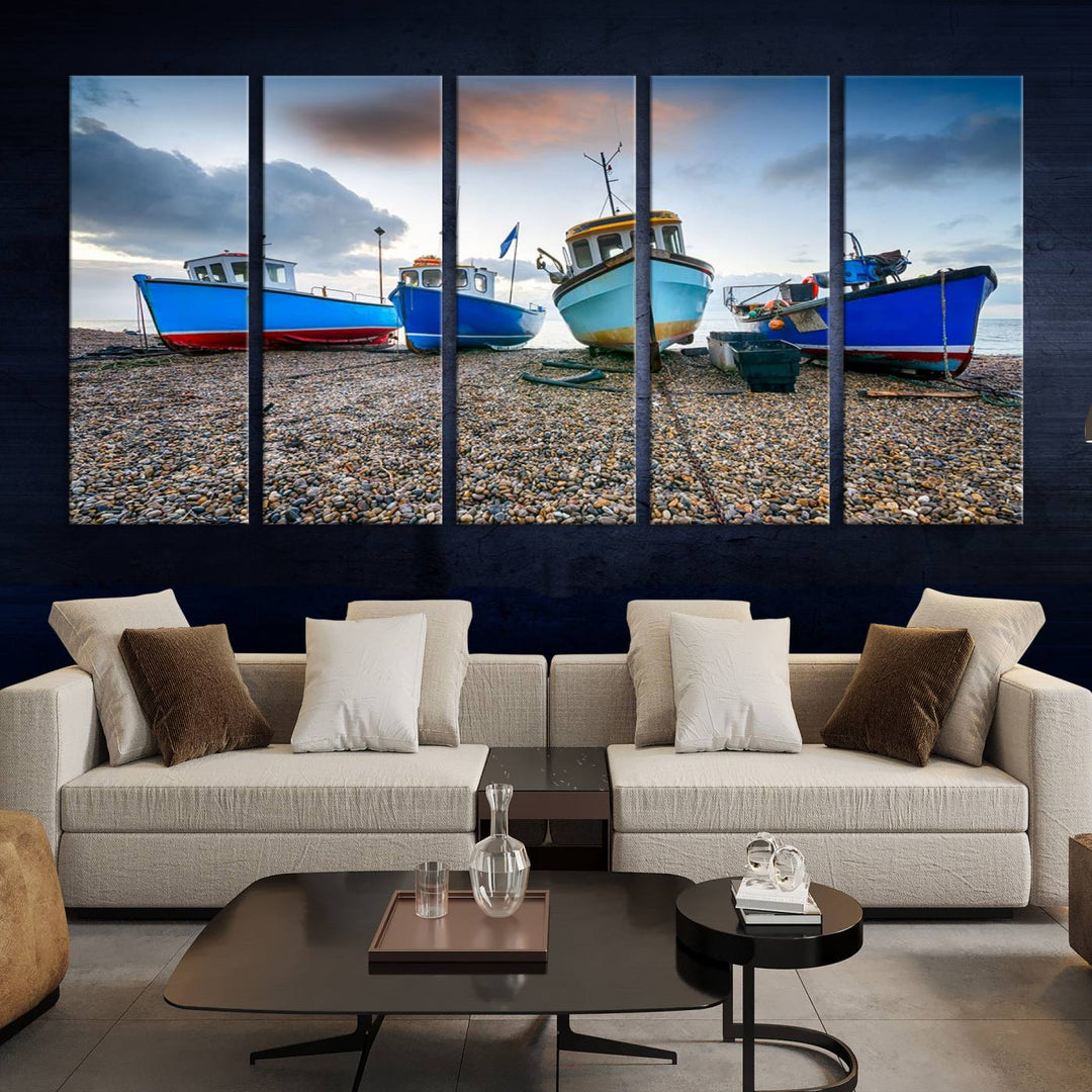 The "Big Boats On The Beach Wall Art Canvas Print" is a stunning piece featuring three museum-quality panels depicting fishing boats on a pebbled shore. Ready to hang and featuring UV-protective coating, it serves as an elegant addition to your home décor.