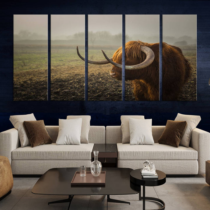 The "Big Cow Horn Wall Art Canvas Print" is a hand-assembled framed canvas depicting a Highland cow in a misty field. It is crafted with a UV-protective coating to ensure lasting vibrancy.