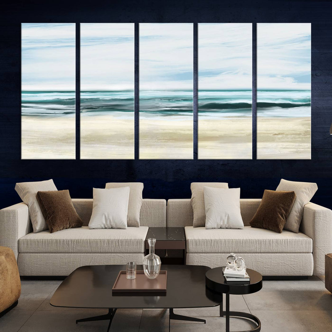 The room features the Ocean Abstract Wall Art Canvas Print, a triptych beach painting on museum-quality canvas with a gallery-wrapped finish and UV-protective coating.