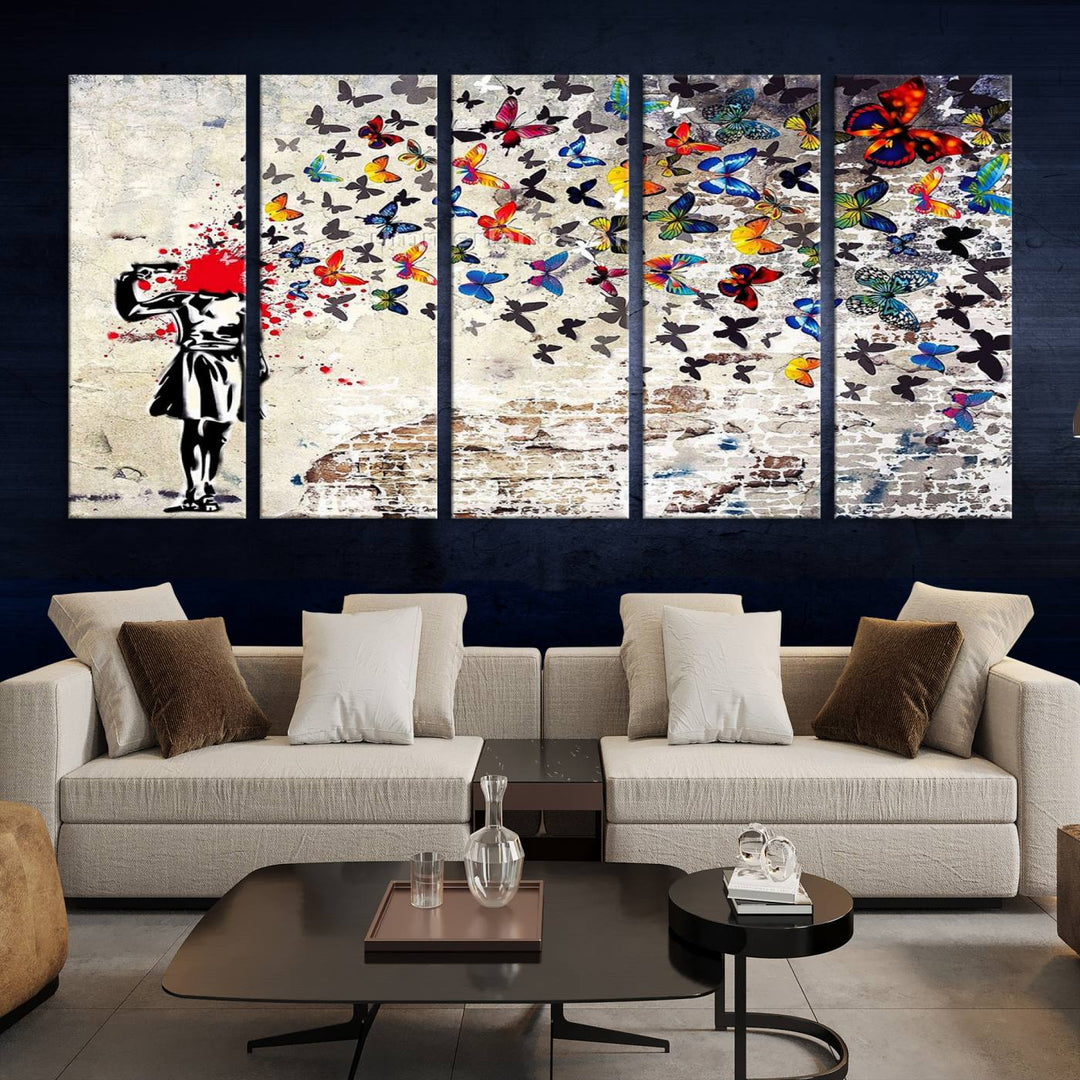 The Banksy Art Butterfly Girl Explosion Canvas showcases a dynamic figure with butterflies bursting from their head, set against a textured wall background. This vibrant urban graffiti piece is perfect for modern interiors and comes ready to hang.