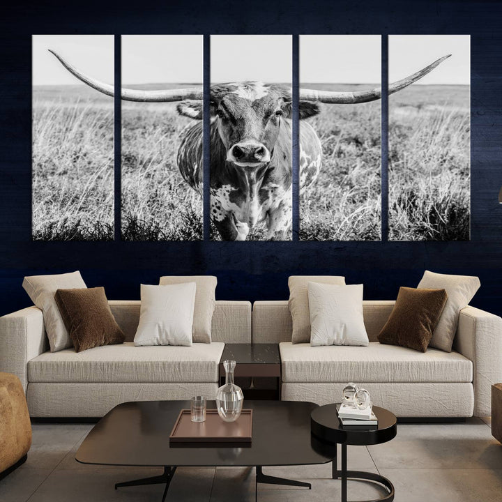 The Texas Cow Longhorn Wall Art Canvas Print is a black and white triptych depicting a cow in a field. It is crafted with museum-quality canvas and features a UV-protective coating.