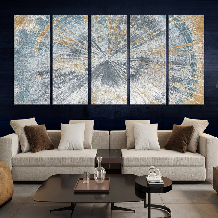 The Radiant Abstract Wood Rings Canvas Art, a modern triptych wall decor, enhances the contemporary style of the living room with its blue, white, and gold hues.