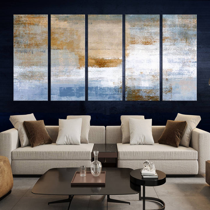 The Blue Multi Panel Abstract Wall Art Canvas Print, featuring an elegant blend of blue, beige, and brown tones, hangs gracefully on the wall, adding a contemporary touch to the space.