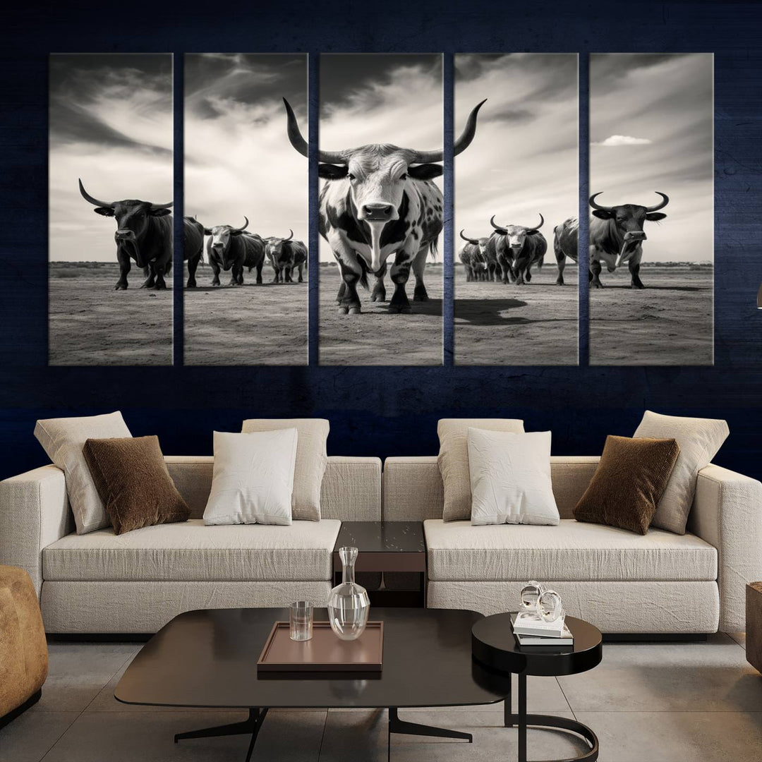 The Black and White Longhorn Cattle Wall Art, featuring a three-panel display of cowboy Western longhorns walking toward the viewer, enhances your space with its striking presence, adding a touch of Western decor.