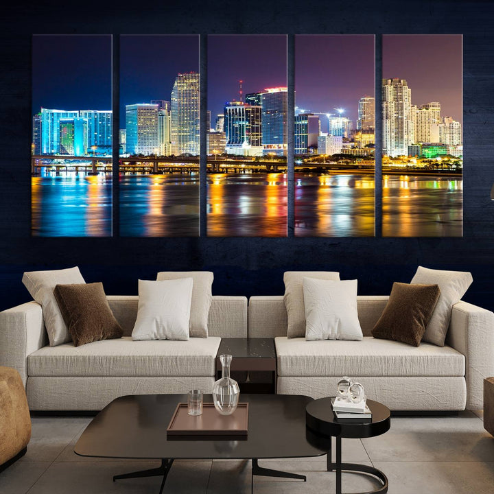 The Wall Art MIAMI Canvas Print features a stunning triptych of a city skyline at night, with vibrant lights reflecting on the water. This gallery-wrapped piece on museum-quality canvas delivers an exquisite finish.