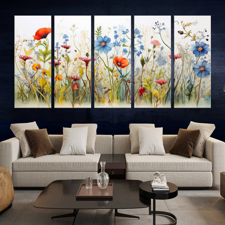 The Colorful Wildflower Canvas Wall Art – Vibrant Floral Botanical Print, consisting of a large 3 panel set, adds bright nature decor to the living room against a black wall.