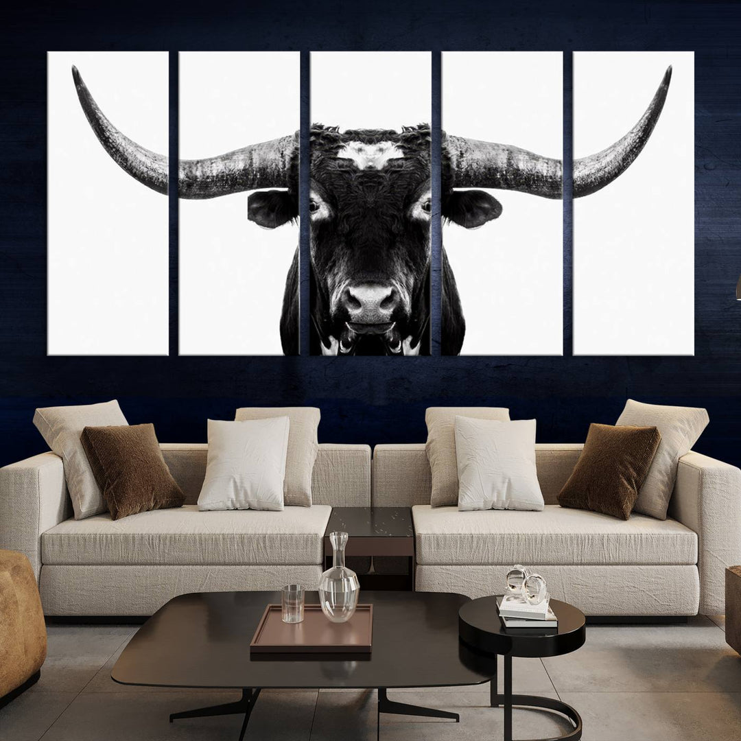 The living room is adorned with the Texas Cow Longhorn Wall Art Canvas Print in Black and White—framed and ready to hang.