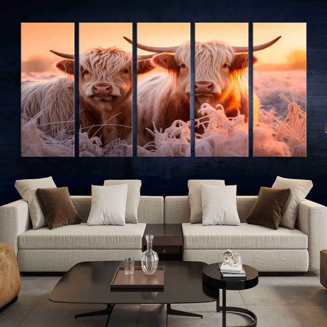 The "Highland Cows at Sunrise Wall Art Canvas Set" beautifully captures a serene and rustic farmhouse aesthetic, portraying two Highland cows in a frosty landscape at sunrise.