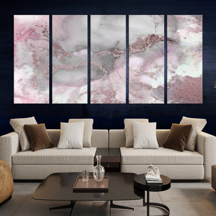 The Rose Marble Abstract Wall Art Canvas Print is a stunning triptych that showcases pink and gray tones, elegantly presented on a dark wall.