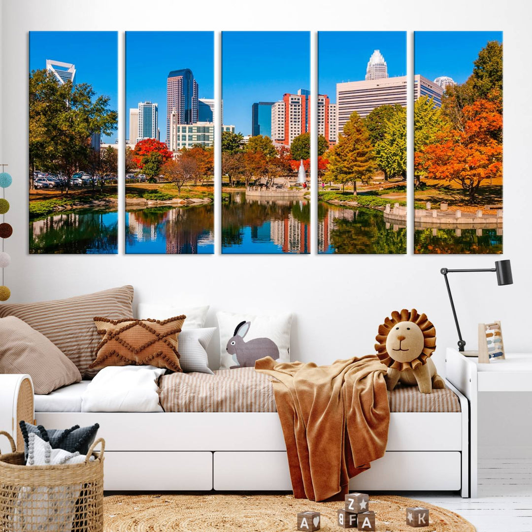 The Charlotte City Park at Fall Skyline Cityscape View wall art canvas print features a city panorama with a park and lake accented by autumn trees. It is mounted on museum-quality canvas with UV-protective coating and decorates the space.