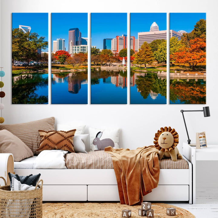 The "Charlotte City Autumn Morning Blue Skyline Cityscape View Wall Art Canvas Print" showcases a cityscape with vibrant autumn trees reflected in a lake. Its gallery-wrapped edges add depth to the scene, while the UV-protective coating ensures lasting brilliance.