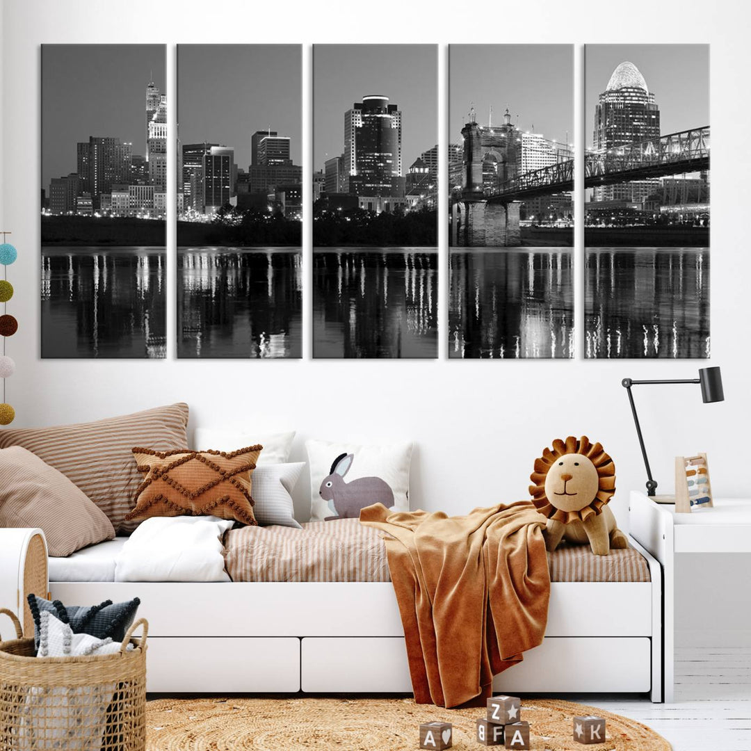 The wall showcases a ready-to-hang triptych of the Cincinnati City Lights Skyline in black and white, printed on museum-quality canvas.